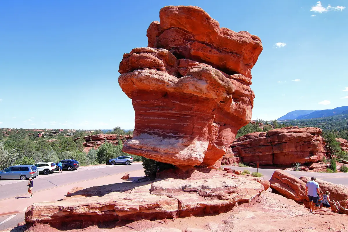 Balanced Rock beside the park road with visitors at its base
