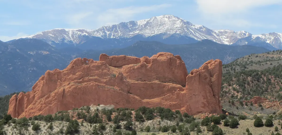Red sandstone fins of Garden of the Gods with Pikes Peak in the background
